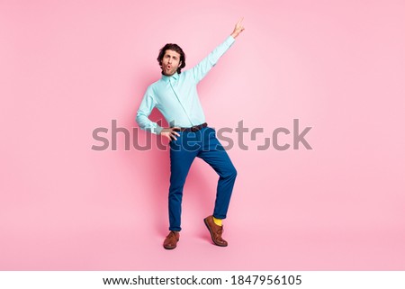 Full body photo of young attractive man excited cool crazy enjoy music dance isolated over pink color background