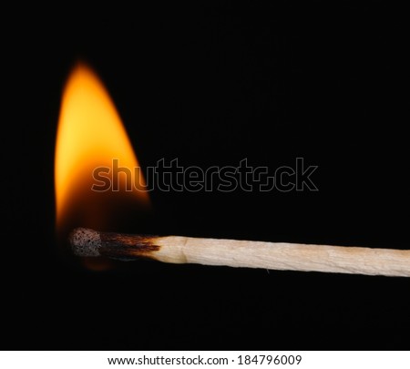 Burning match isolated on black Royalty-Free Stock Photo #184796009