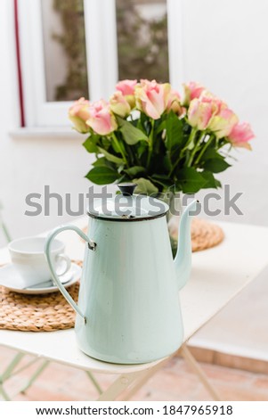 Vintage enamel tea pot pale blue with bouquete of pink roses