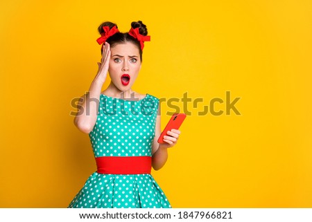 Photo of astonished girl use cellphone touch hand head wear teal clothes isolated bright color background