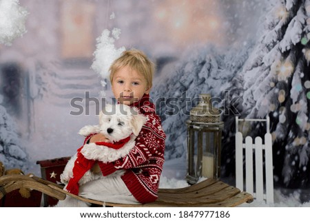 Cute boy, preschool child, playing in the snow outdoors, studio shot