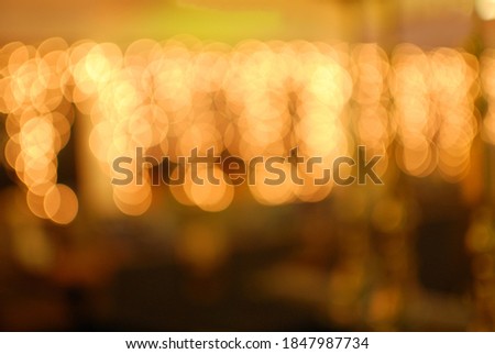 Blurred background. Bright glowing yellow-orange New Year, Christmas garland out of focus. Space for an inscription at the bottom. Congratulations. Holidays. Winter.