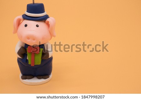Christmas toy in the form of a pig isolated on yellow background