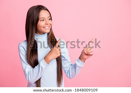 Photo of charming girl direct hands empty space casual blue turtleneck isolated on pink color background