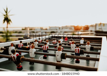 A closeup of a table football in the open air