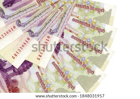 100 Cambodian riels bills lies isolated on white background with copy space stacked in fan shape close up