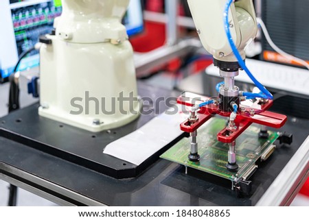 high technology and precision robot arm and automatic vacuum or suction cup for pick & place transportation pcb or material goods or product of manufacturing process in industrial Royalty-Free Stock Photo #1848048865