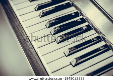 Old piano keys close up. Vintage photo.