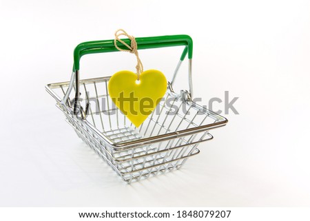 Shopping basket and heart label on white background. Sale and discount concept.