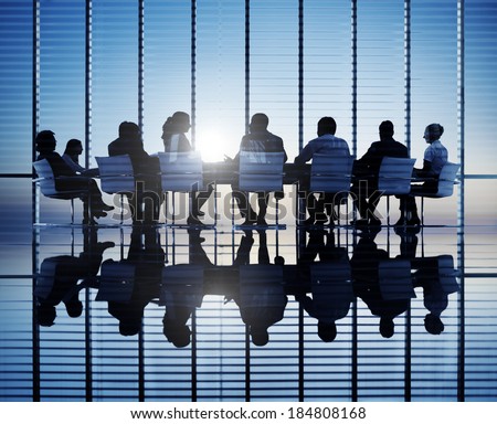Silhouettes of business people in a conference room. Royalty-Free Stock Photo #184808168