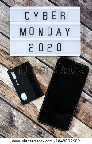 cyber monday word written on lightbox on brown wooden background. Flat lay, top view. 04.11.2020 - Moscow