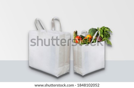 eco friendly white mockup bags on white table with background. Non woven bags mock-up