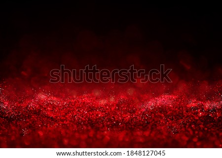 Red glitter vintage lights background defocused for festivals and celebrations