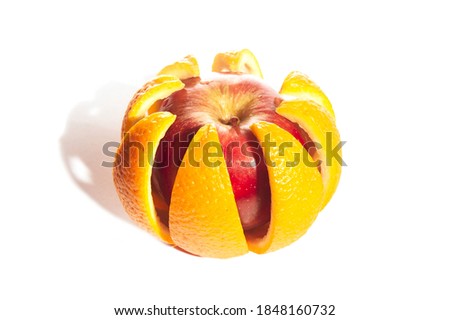 red apple in opened peel from an orange. Isolated on white. Foodporn fruit. diet concept Royalty-Free Stock Photo #1848160732