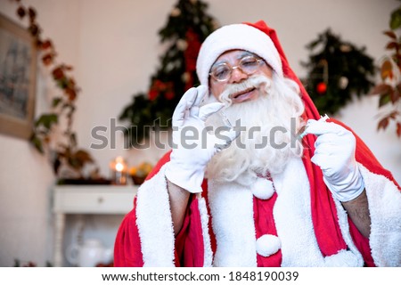 Santa Claus holding New Vaccine and syringe. Coronavirus Vaccine dose delivery as Christmas Gift