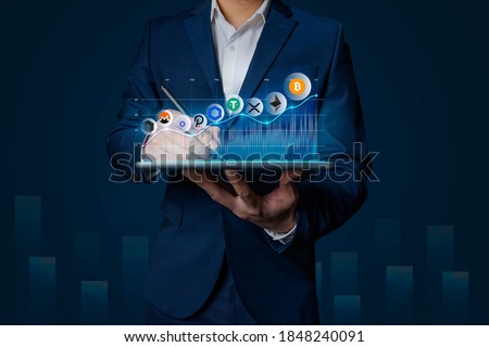 Cryptocurrency altcoin, Business man holding tablet showing growing virtual hologram of altcoin crypto and bitcoin, xrp, chainlink, ethereum Royalty-Free Stock Photo #1848240091