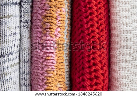 Texture of knitted sweaters close up. Background from warm woolen jumpers.