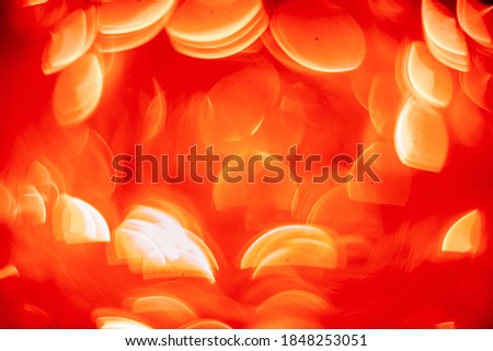 Abstract background with christmas lights in boken. Bright red trending color texture for design. Background concept.