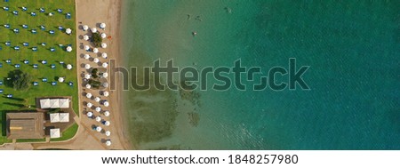 Aerial drone top down photo of beautiful organised beach in Mediterranean popular destination