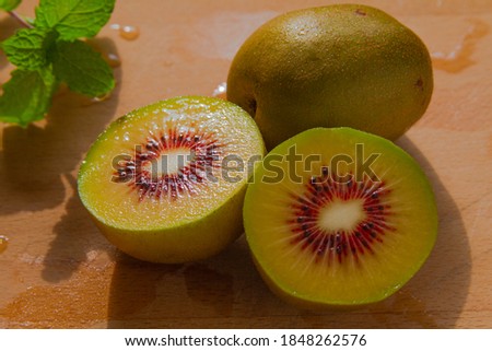 Red kiwi fruit cultivars halves close up Royalty-Free Stock Photo #1848262576