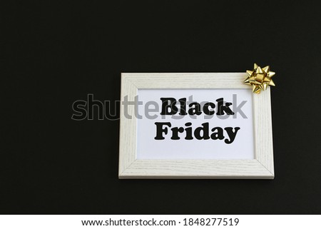 White wooden frame with text in center on the black background. Black Friday concept, discounts and sale. 