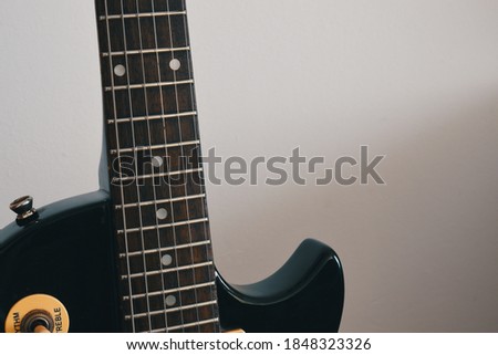 macro view of the neck of an electric guitar