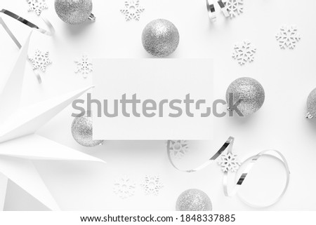 A closeup of Christmas silver  decorations  on a white background