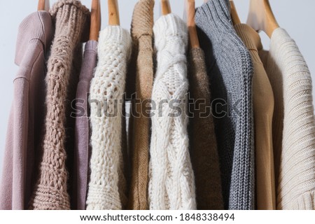 Row of multicolored turtleneck knitwear ,sweater warm cloth on hangers. Fashion concept.

 Royalty-Free Stock Photo #1848338494