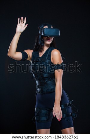A young woman in a virtual reality suit that allows her whole body to plunge into VR. EMS.