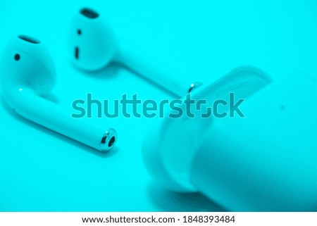 Left and Right Wireless White Headphone with white charging case 