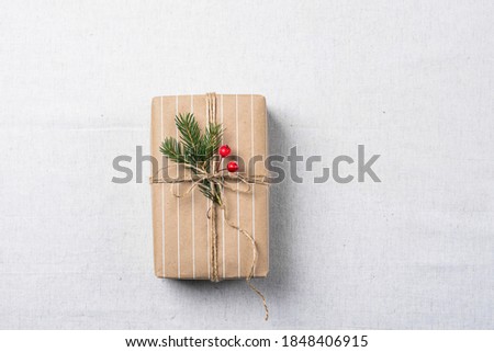 Gift wrapped in paper background of natural linen material. Zero West concept