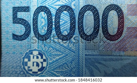 Money; Close up macro detail of Indonesian Rupiah banknotes; detail photo of Rupiah. World money concept, inflation and economy concept.