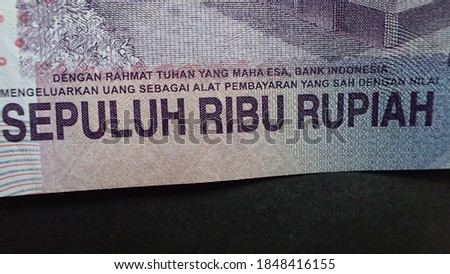 Money; Close up macro detail of Indonesian Rupiah banknotes; detail photo of Rupiah. World money concept, inflation and economy concept.