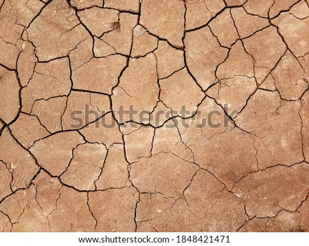 The ground has cracks in the top view for the background or graphic design with the concept of drought and death. Royalty-Free Stock Photo #1848421471