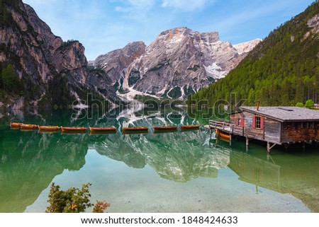panoramic view of Mount Seekofel and boatshouse mirroring in the clear calm water of iconic mountain lake Pragser Wildsee (Lago di Braies) in Dolomites, Unesco World Heritage, South Tyrol, Italy Royalty-Free Stock Photo #1848424633