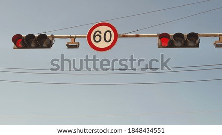 Red Traffic Light And Speed Limit Sign
