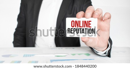 businessman holding a card with text ONLINE REPUTATION