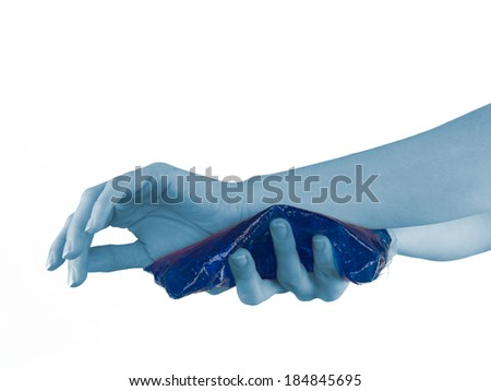 Cool gel pack on a swollen hurting wrist. Medical concept photo. 