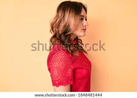Young beautiful caucasian woman wearing casual clothes looking to side, relax profile pose with natural face with confident smile. 