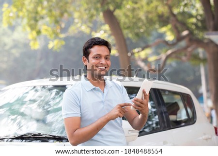 Indian businessman using digital tablet on the way to work