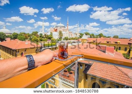 Selective focus on glass of tea the background of the Hagia Sophia. With a soft blurred background. Turkish Hagia Sophia has become a mosque.