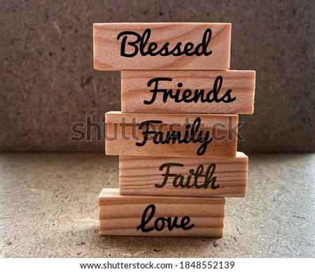 Text such as blessed, friends, family, faith and love on small woods