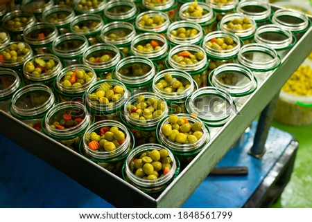 Olives and other ingredients in glass jars for canning. High quality photo