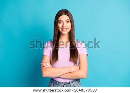Photo of cute sweet woman girl dressed casual purple t-shirt arms crossed look empty space isolated blue color background