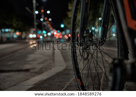 Long exposure of bicycle spokes and passing cars in at Kralja Aleksandra boulevard in Belgrade Royalty-Free Stock Photo #1848589276