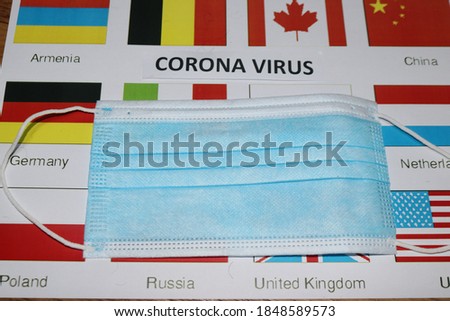 corona virus written on paper and flags