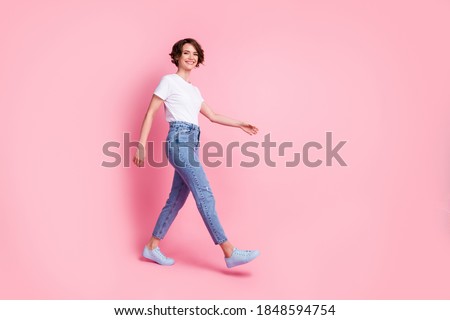 Full length body size profile side view of nice cheerful cheery brown-haired girl wearing comfy clothes walking isolated over pink color background Royalty-Free Stock Photo #1848594754