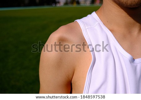 sportsman with shoulder dislocation in turf/sports field. shoulder bone is clarified.  Royalty-Free Stock Photo #1848597538