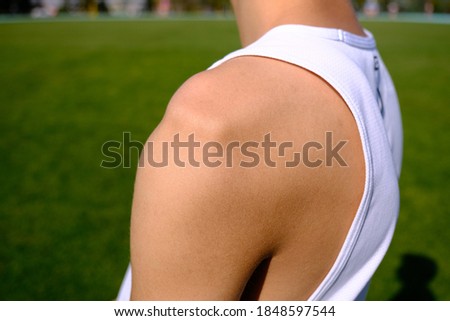 sportsman with shoulder dislocation in turf/sports field. shoulder bone is clarified.  Royalty-Free Stock Photo #1848597544
