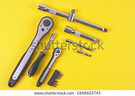 Flat lay with set of tools supplies for repair car on yellow background. Top view with copy space. Royalty-Free Stock Photo #1848603745